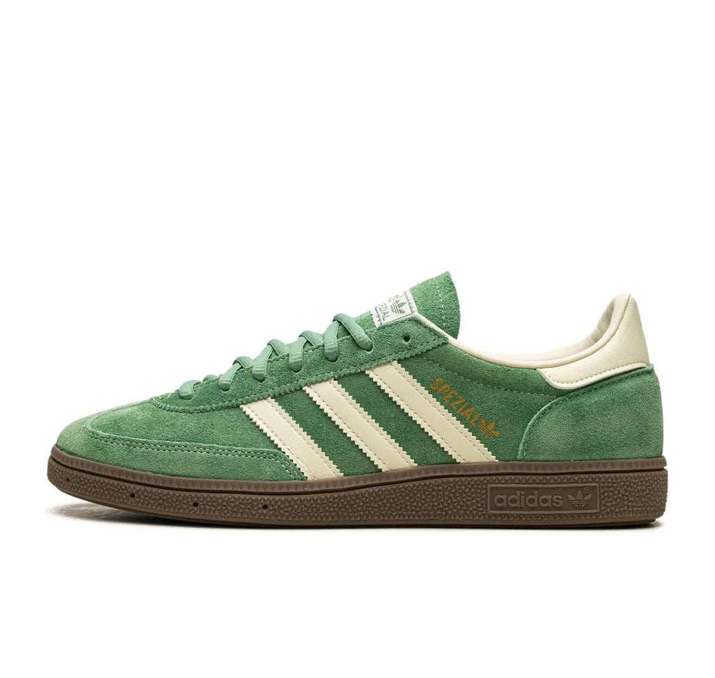 Green Adidas sneaker with white stripes on a white background